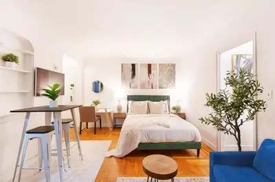 a bedroom with a bed and a table in a room at 105-1G Park Ave Location studio best value Sleeps3 in New York