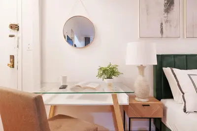 a glass table with a lamp and a mirror at 105-1G Park Ave Location studio best value Sleeps3 in New York