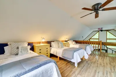 a bedroom with three beds and a ceiling fan at Fire Pit and Grill Woodside Nest in Pocono Lake! in Pocono Lake