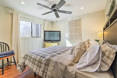 a bedroom with a bed and a ceiling fan at Fire Pit and Grill Woodside Nest in Pocono Lake! in Pocono Lake