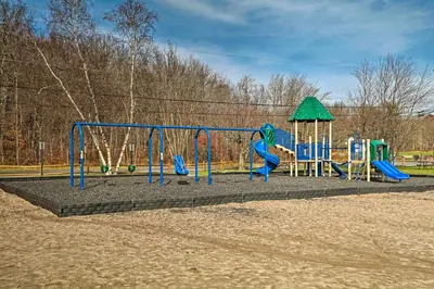 a park with a playground with a slide at Fire Pit and Grill Woodside Nest in Pocono Lake! in Pocono Lake