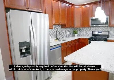 a kitchen with a stainless steel refrigerator and a counter at Newly Renovated Guest Rooms near Transportation in Philadelphia