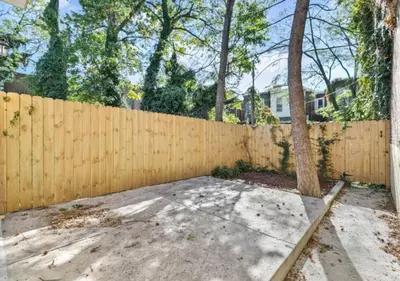 a wooden fence with a tree in front of it at Newly Renovated Guest Rooms near Transportation in Philadelphia