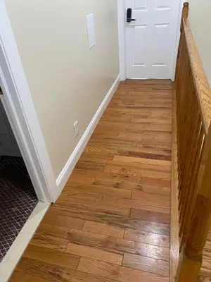 a hallway with a wooden floor and a white door at Newly Renovated Guest Rooms near Transportation in Philadelphia