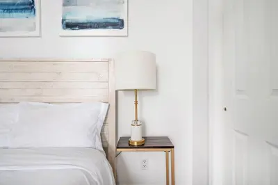 a bedroom with a bed and a lamp on a table at 69-2B Prime Lower East East BRAND NEW 1br Apt in New York