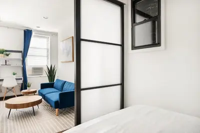 a bedroom with a blue couch and a blue chair at 69-2B Prime Lower East East BRAND NEW 1br Apt in New York