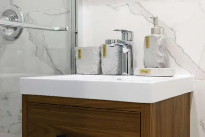 a white sink in a bathroom with a shower at 69-2A PRIME Lower East Side 1br Apt Brand New in New York