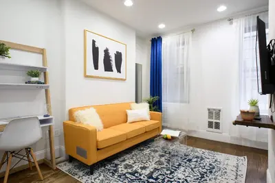 a living room with a couch and a rug at 69-2A PRIME Lower East Side 1br Apt Brand New in New York