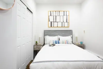 a white bedroom with a large bed and a window at 69-2A PRIME Lower East Side 1br Apt Brand New in New York
