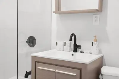 a bathroom with a sink and a shower at 69-2C Brand New PRIME Lower East Side 1br Apt in New York