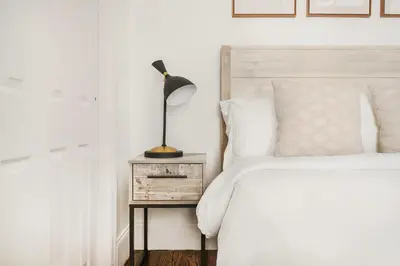 a bedroom with a bed and a lamp on a night stand at 69-3A Prime LES Modern Brand New 1BR in New York
