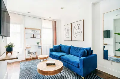 a living room with a blue couch and a table at 69-3B Prime Lower East Side BRAND NEW 1br Apt in New York