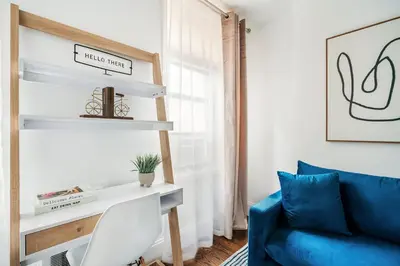 a living room with a blue couch and a desk at 69-3B Prime Lower East Side BRAND NEW 1br Apt in New York