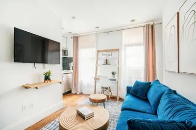 a living room with a blue couch and a table at 69-3B Prime Lower East Side BRAND NEW 1br Apt in New York