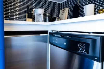 a kitchen with a stainless steel refrigerator and a shelf at 69-3C Stylish Lower East East 1br Apt BRAND NEW in New York
