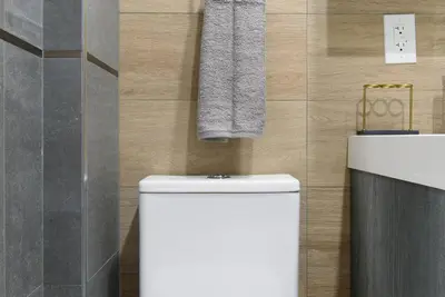 a bathroom with a toilet and a sink and a towel at 24-14 Renovated studio Prime gramercy W D in New York