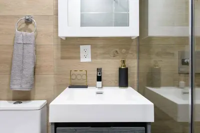 a bathroom with a white sink and a toilet at 24-14 Renovated studio Prime gramercy W D in New York