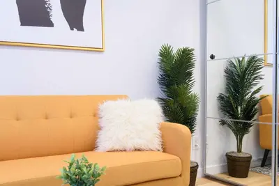 a living room with a couch and two plants at 69-3D Prime Lower East East BRAND NEW 1br Apt in New York