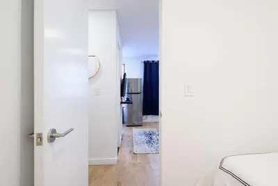 a white door leading into a room with a kitchen at 69-3D Prime Lower East East BRAND NEW 1br Apt in New York
