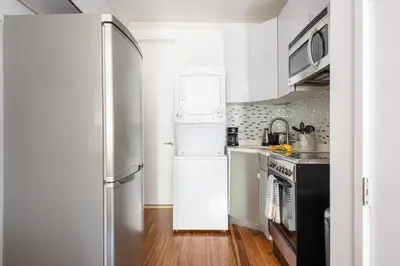 a kitchen with white appliances and a refrigerator at 24-16 Studio Gramercy W D gramercy in New York