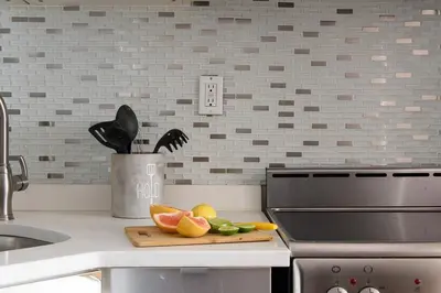 a kitchen counter with a cutting board with fruit on it at 24-16 Studio Gramercy W D gramercy in New York