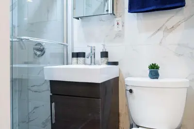 a bathroom with a toilet and a sink and a shower at 69-4A Quality NEW Prime Lower East East 1br Apt in New York