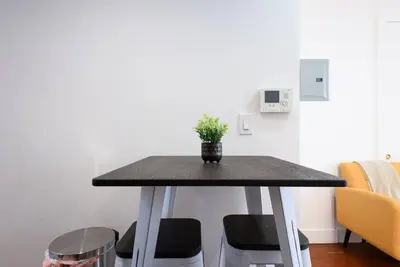 a table with a potted plant sitting on top of it at 24-17 Renovated Studio Prime Location WD in New York