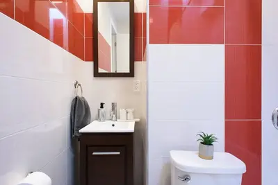 a bathroom with a white toilet and a sink at 24-17 Renovated Studio Prime Location WD in New York