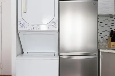 a refrigerator and a stove in a kitchen at 24-18 New Gramercy Studio W D in Unit Fully Reno in New York