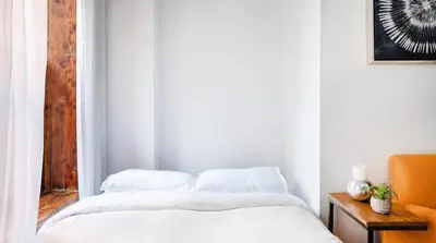 a white bedroom with a bed and a mirror at 24-3 Prime Gramercy New Studio W D Terrace in New York