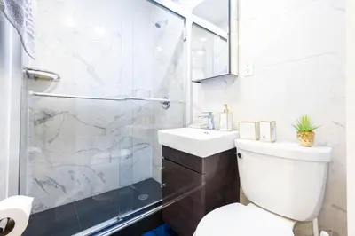 a bathroom with a shower and a toilet and a sink at 69-4C PRIME Lower East Side 1br Apt Brand New in New York