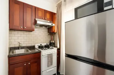 a kitchen with a white stove and a sink at 69-4D Trendy Lower East Side 1B BRAND NEW in New York