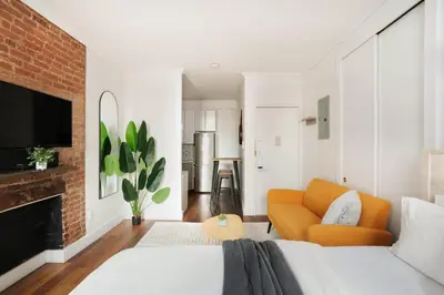 a living room with a bed and a couch at 24-4 New Private Terrace W D Apt Prime Gramercy in New York