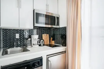 a kitchen with a sink and a microwave at 69-5B I Stylish Lower East Side 1BR Apt BRAND NEW in New York
