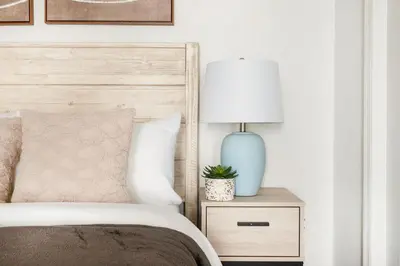 a bedroom with a bed and a lamp on a night stand at 69-5B I Stylish Lower East Side 1BR Apt BRAND NEW in New York
