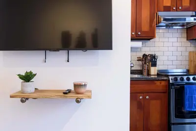 a kitchen with a wooden shelf on the wall at 69-5D Modern Lower East East 1br Apt BRAND NEW in New York