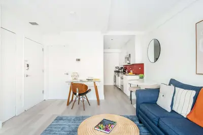 a living room with a blue couch and a table at 809-2A Gorgeous 1BR New W D Modern Best Location in New York