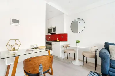 a kitchen and living room with a table and a blue couch at 809-2A Gorgeous 1BR New W D Modern Best Location in New York