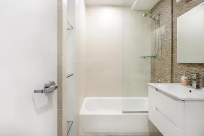 a white bathroom with a sink and a shower at 809-2A Gorgeous 1BR New W D Modern Best Location in New York