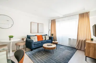 a living room with a blue couch and a table at 809-2A Gorgeous 1BR New W D Modern Best Location in New York