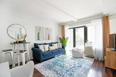 a living room with a blue couch and a table at 809-3A 1BR Columbus Circle Elevator W D in New York
