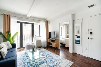 a living room with a couch and a bed at 809-3A 1BR Columbus Circle Elevator W D in New York