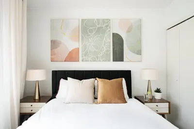 a bedroom with a white bed with two lamps at 809-3A 1BR Columbus Circle Elevator W D in New York