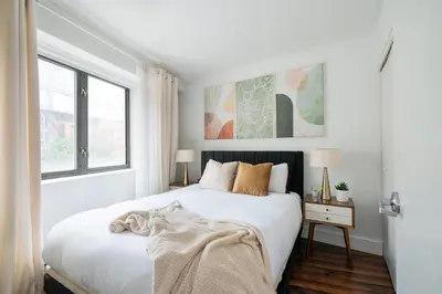 a white bedroom with a bed and a window at 809-3A 1BR Columbus Circle Elevator W D in New York