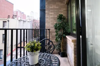 a table with a potted plant on a balcony at 809-3B Columbus Circle W D new BLDG Balcony in New York