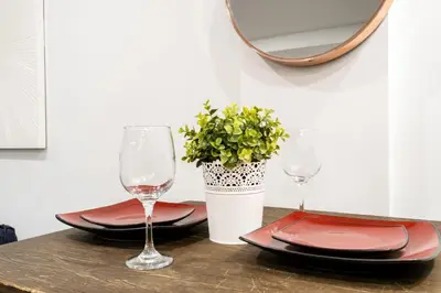 a table with two plates and glasses and a mirror at 809-3B Columbus Circle W D new BLDG Balcony in New York