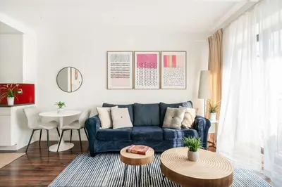a living room with a blue couch and a table at 809-4A Columbus Circle New BLDG 1BR W D in New York