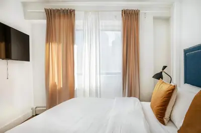 a bedroom with a white bed and a window at 809-4A Columbus Circle New BLDG 1BR W D in New York