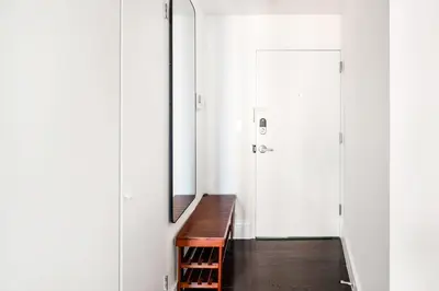 a dressing room with a bench and a mirror at 809-4B Studio Balcony W D Prime location in New York
