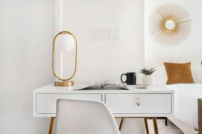 a white desk with a mirror and a chair at 809-4B Studio Balcony W D Prime location in New York